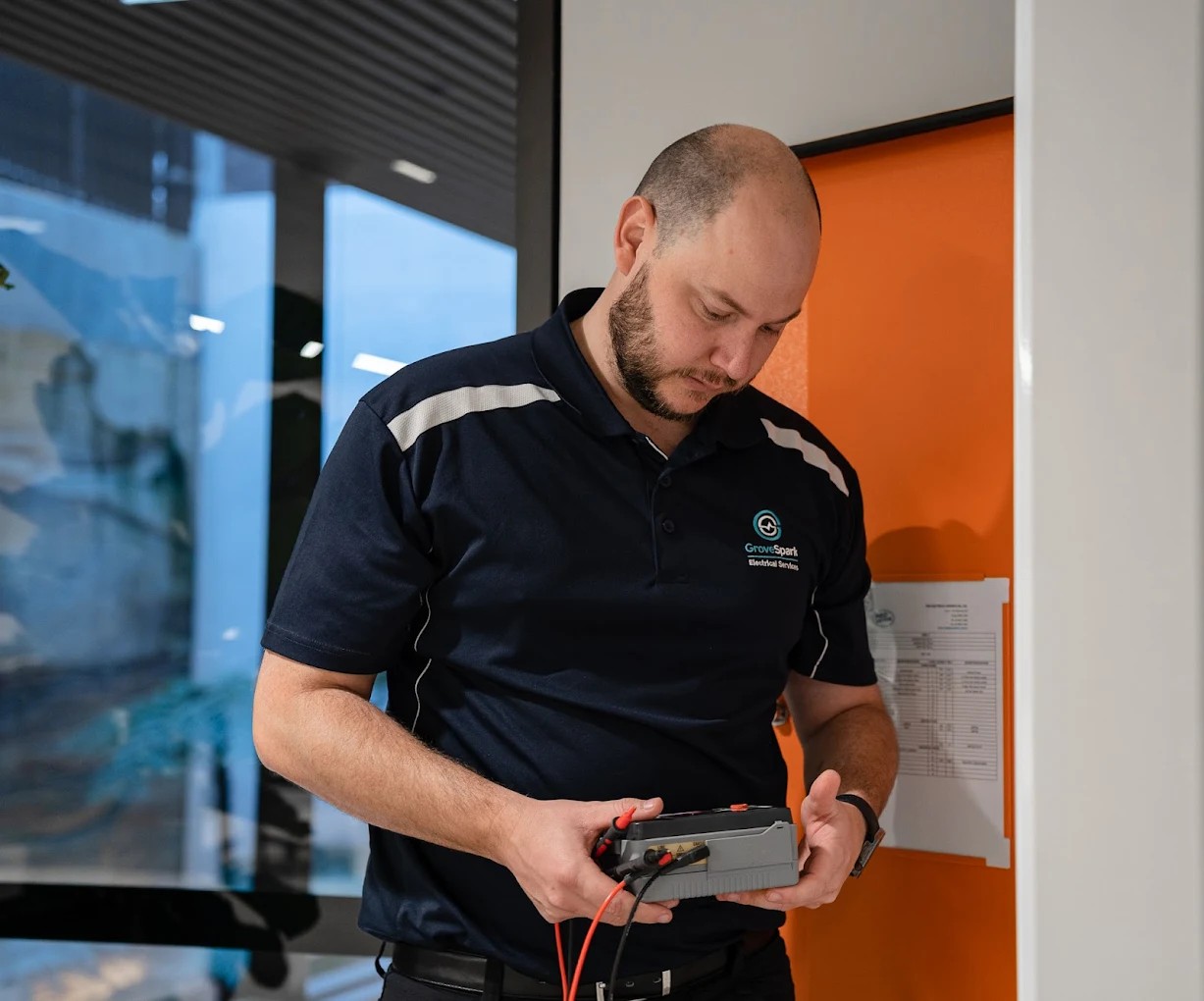 Emergency electrician Chatswood — Grove Spark technician inspecting tripped safety switch in residential switchboard